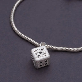 Pingente dado em Prata 925 com design artesanal sobre pulseira de prata
